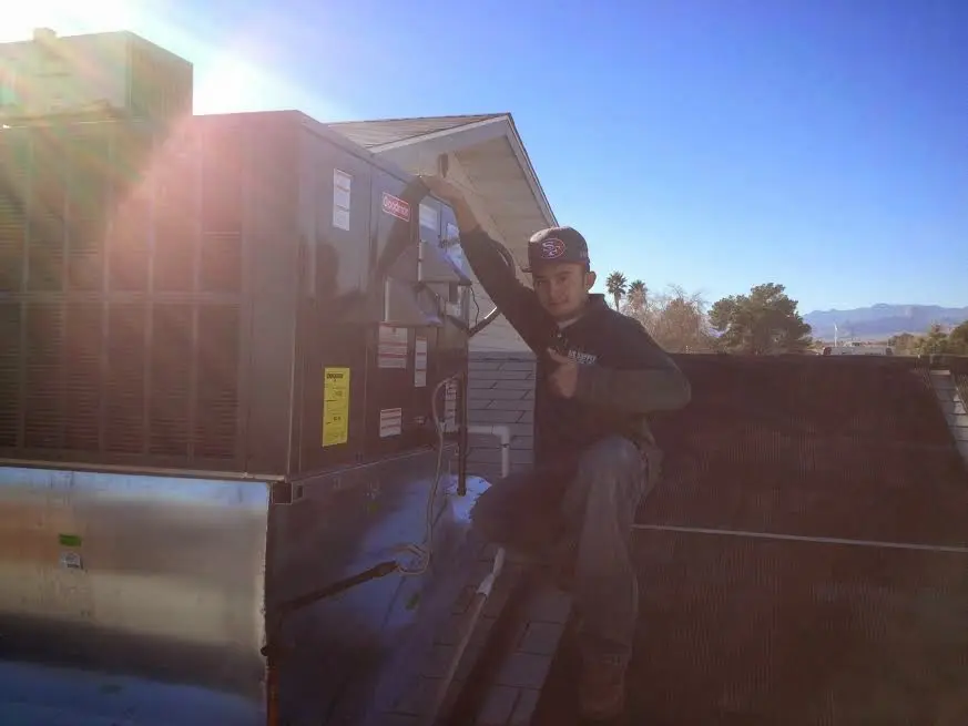 HVAC technician performing AC Tune-Up on a rooftop unit in West Chester